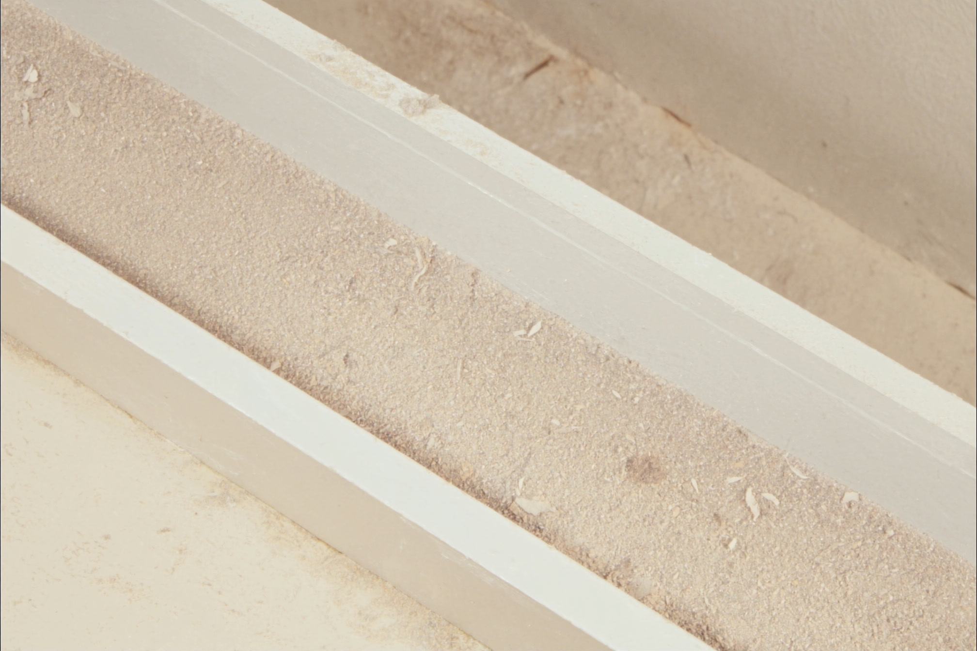 Fine dust on a window sill and a freshly trowel-finished wall after renovation work